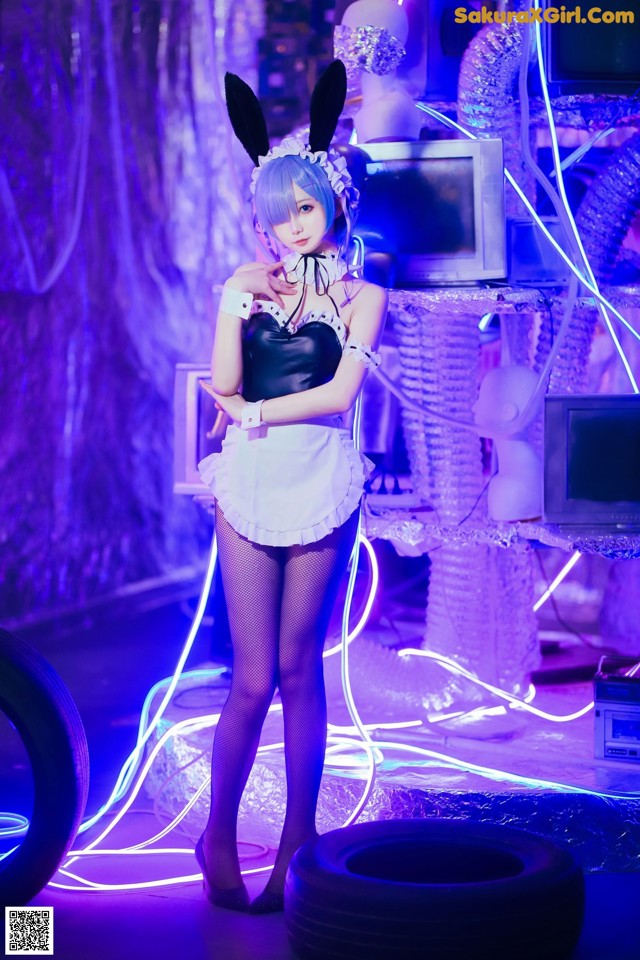 A woman in a bunny costume standing in front of a stage.